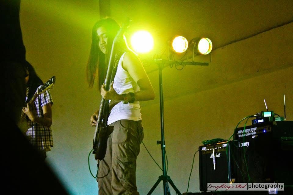 Camille playing bass on stage during college